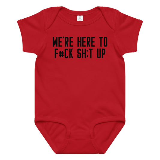 "We're Here To F#Ck Sh:t Up" printed on a red baby jersey bodysuit laying on a flat surface amongst other clothes