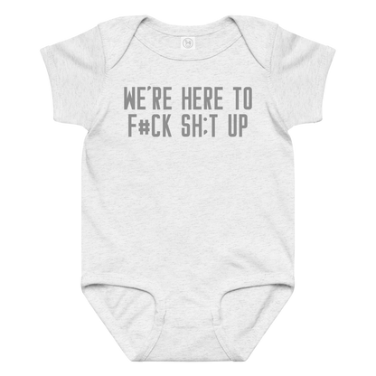 "We're Here To F#Ck Sh:t Up" printed on a ash baby jersey bodysuit laying on a flat surface amongst other clothes
