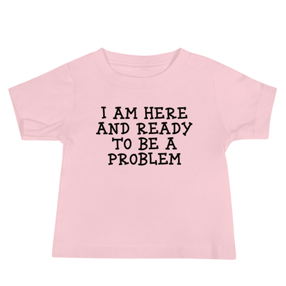 "I am here and ready to be a problem" printed on a pink baby jersey short sleeve tee laying on a flat surface