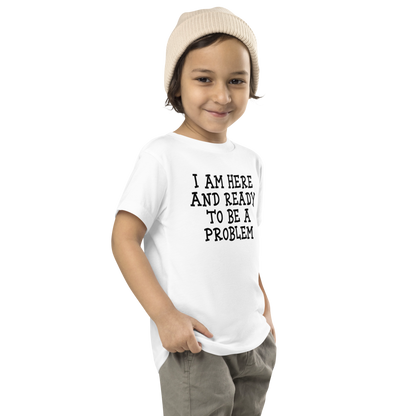 "I am here and ready to be a problem" printed on a white toddler short sleeve tee worn by a male who is also wearing a knit cap