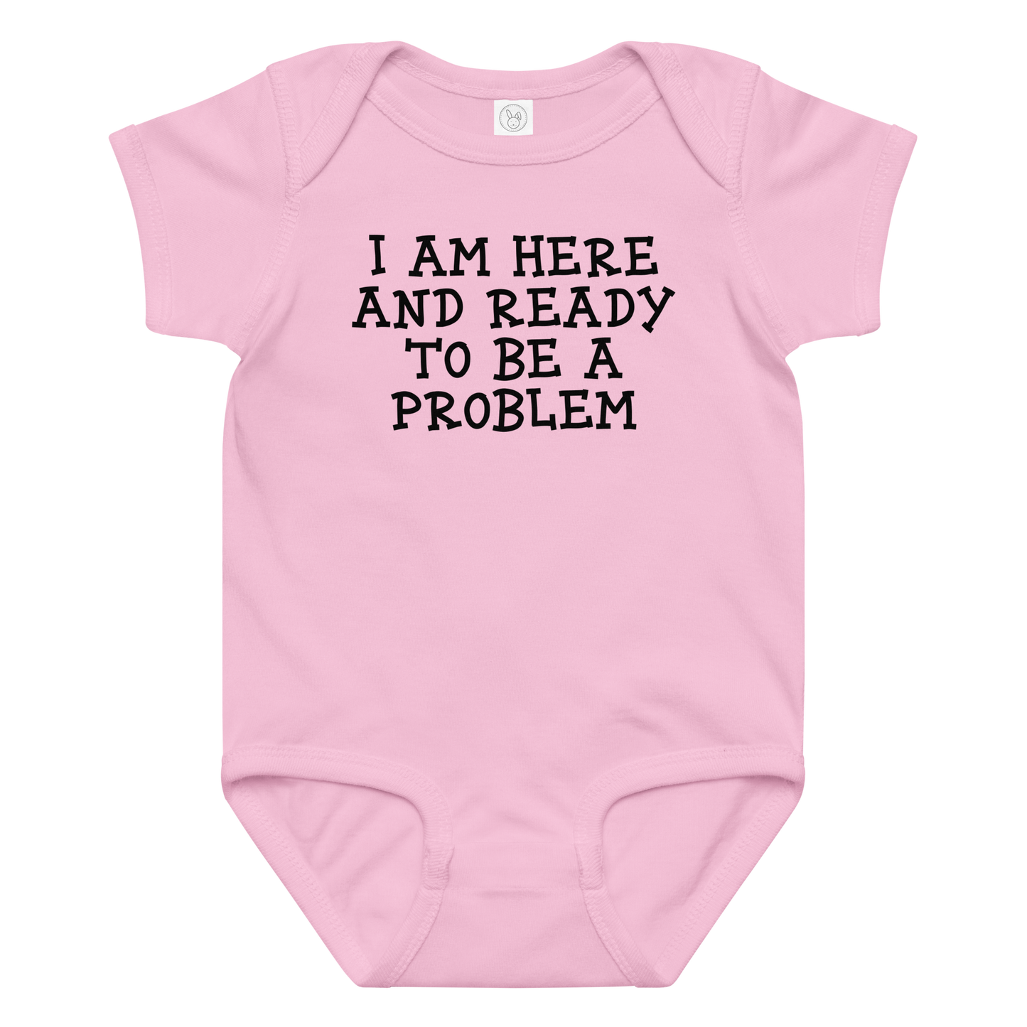 "I am here and ready to be a problem" printed on a pink baby jersey bodysuit laying on a flat surface amongst other clothes