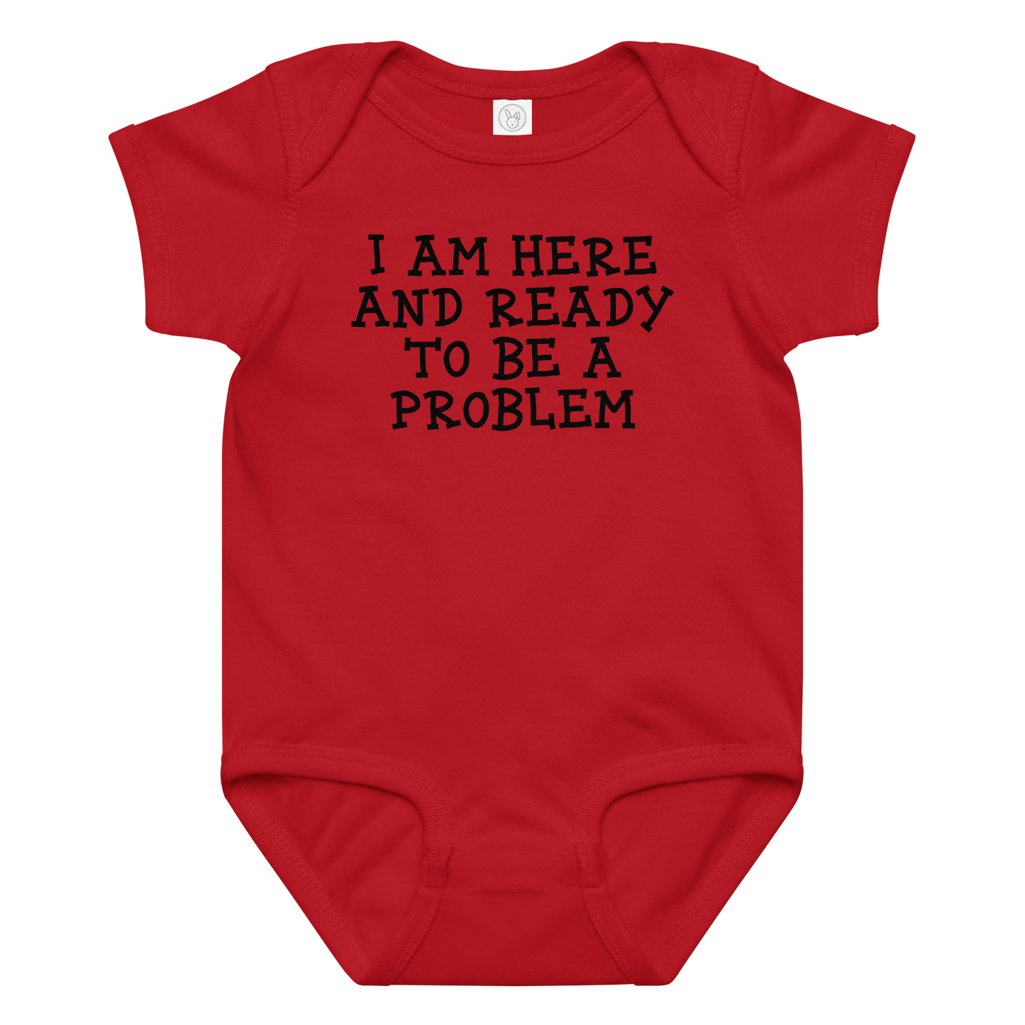 "I am here and ready to be a problem" printed on a red baby jersey bodysuit laying on a flat surface amongst other clothes