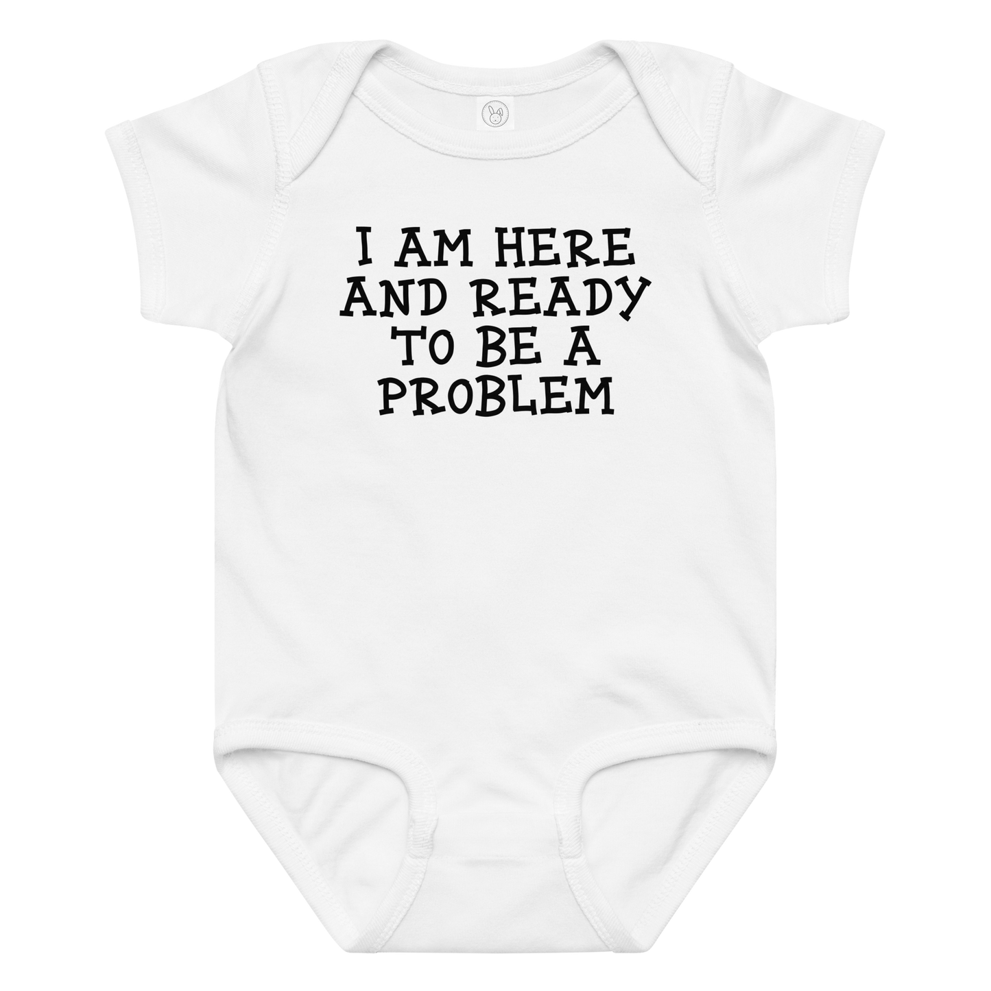 "I am here and ready to be a problem" printed on a white baby jersey bodysuit laying on a flat surface amongst other clothes