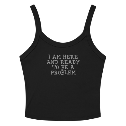 "I am here and ready to be a problem" printed on a solid black blend women's micro-rib tanktop laying on a flat surface amongst sunglasses and shorts