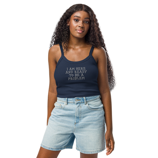 "I am here and ready to be a problem" printed on a solid navy blend women's micro-rib tanktop worn by a female