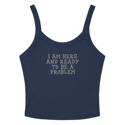 "I am here and ready to be a problem" printed on a solid navy blend women's micro-rib tanktop laying on a flat surface amongst sunglasses and shorts