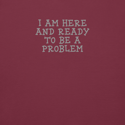 "I am here and ready to be a problem" printed on a maroon background