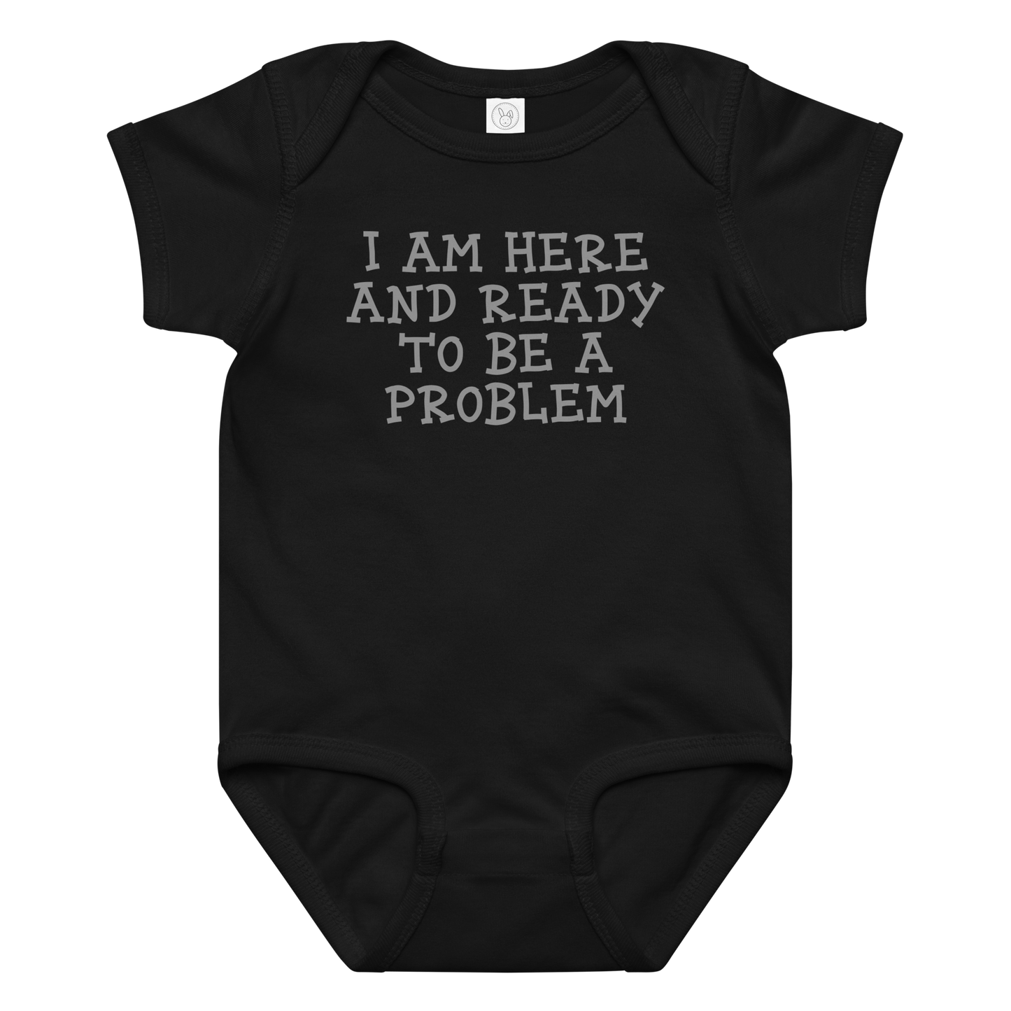 "I am here and ready to be a problem" printed on a black baby jersey bodysuit laying on a flat surface amongst other clothes