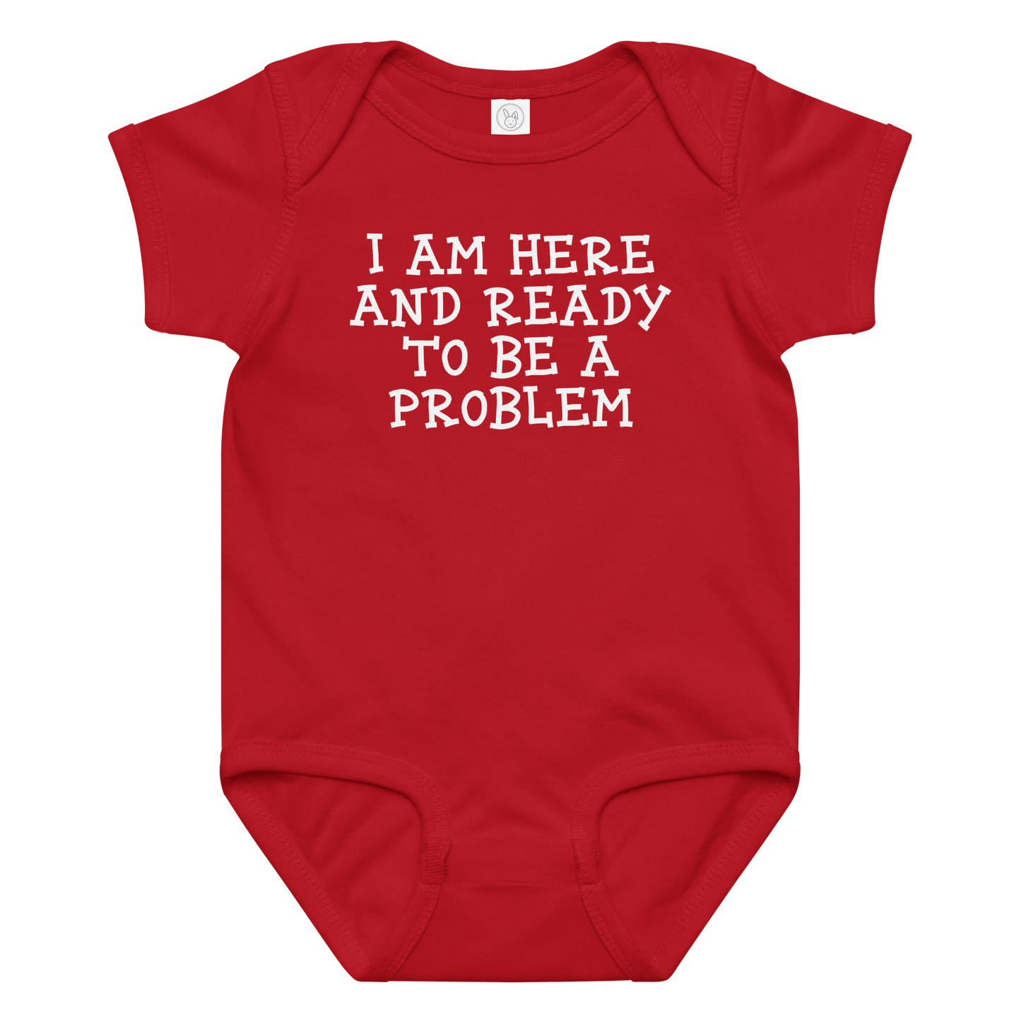 "I am here and ready to be a problem" printed on a red baby jersey bodysuit laying on a flat surface amongst other clothes