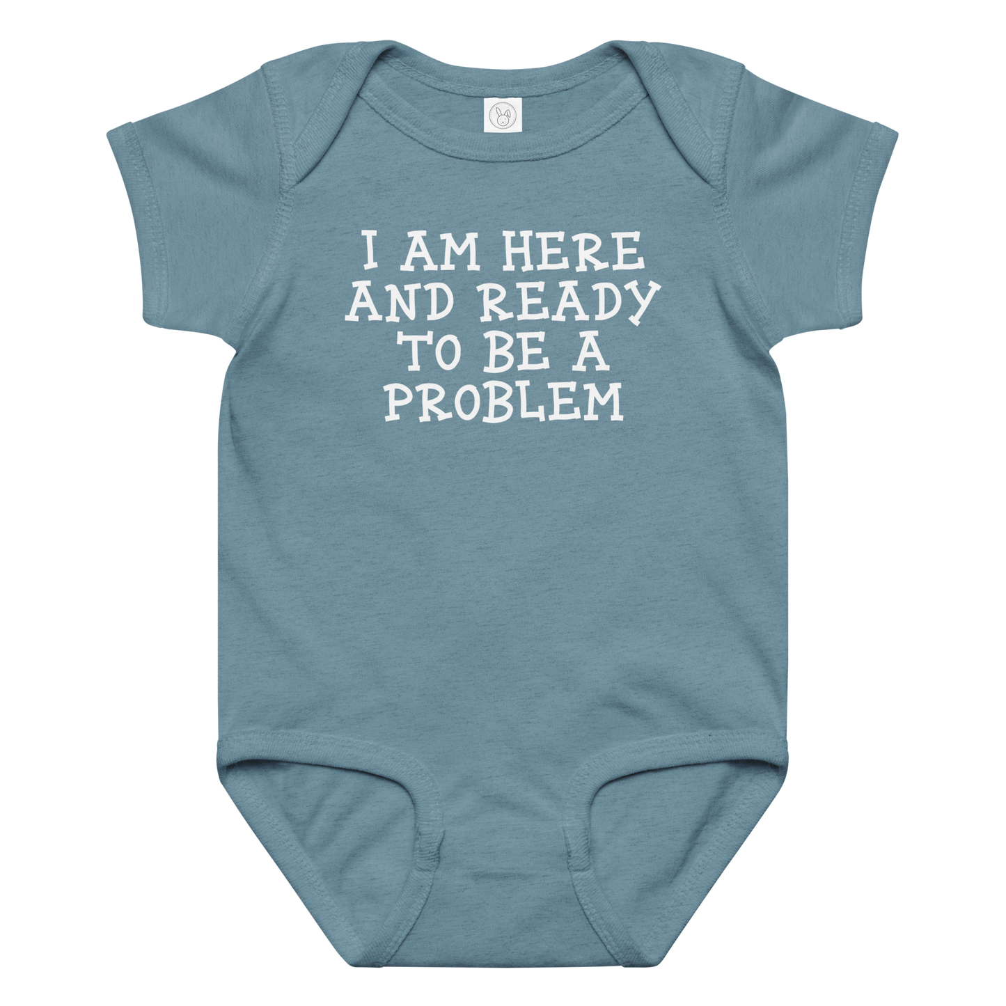 "I am here and ready to be a problem" printed on a vintage indigo baby jersey bodysuit laying on a flat surface amongst other clothes