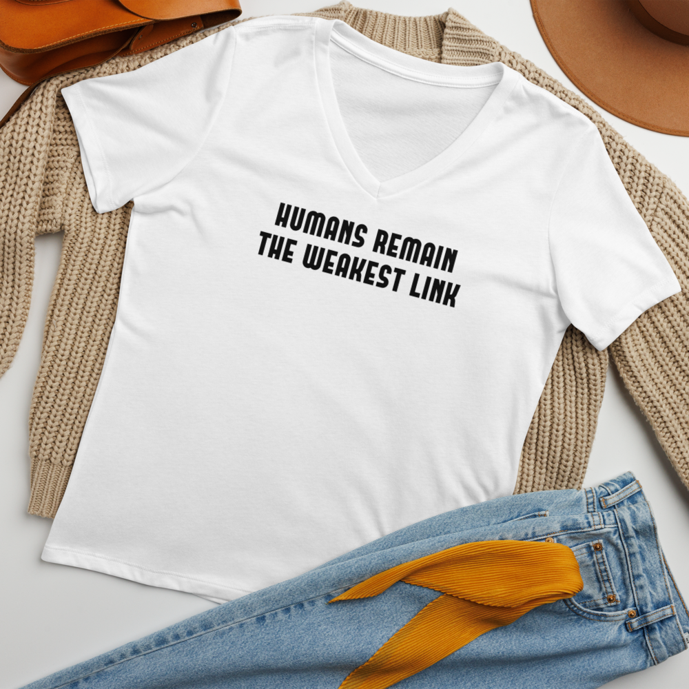 "Humans remain the weakest link" printed on a solid white blend women's relaxed v-neck t-shirt laying on a flat surface amongst other clothes
