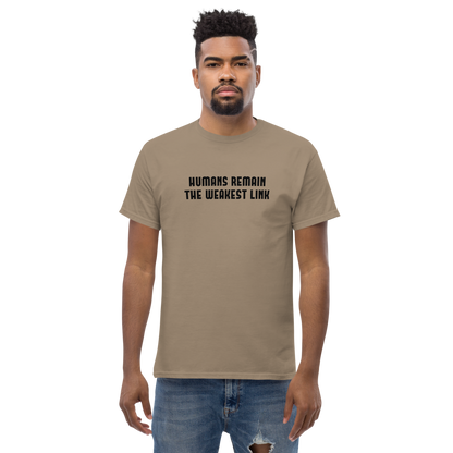"Humans remain the weakest link" printed on a brown savana unisex classic tee worn by a male