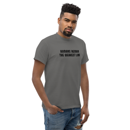 "Humans remain the weakest link" printed on a charcoal unisex classic tee worn by a male