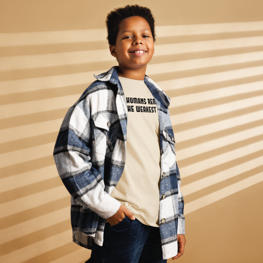 "Humans remain the weakest link" printed on a natural youth classic tee worn by a male also wearing a jacket