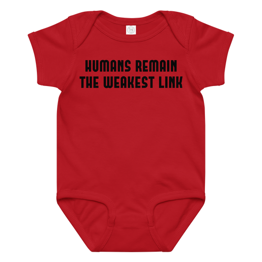 "Humans remain the weakest link" printed on a red baby jersey bodysuit laying on a flat surface amongst other clothes