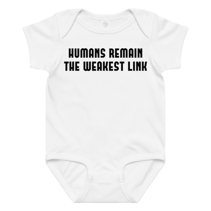 "Humans remain the weakest link" printed on a white baby jersey bodysuit laying on a flat surface amongst other clothes