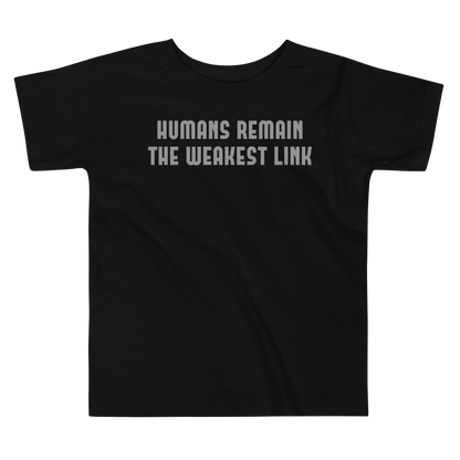 "Humans remain the weakest link" printed on a black toddler short sleeve tee laying on a flat surface