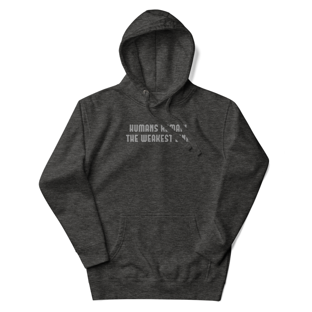 "Humans remain the weakest link" printed on a charcoal heather unisex hoodie laying on a flat surface with the hood up