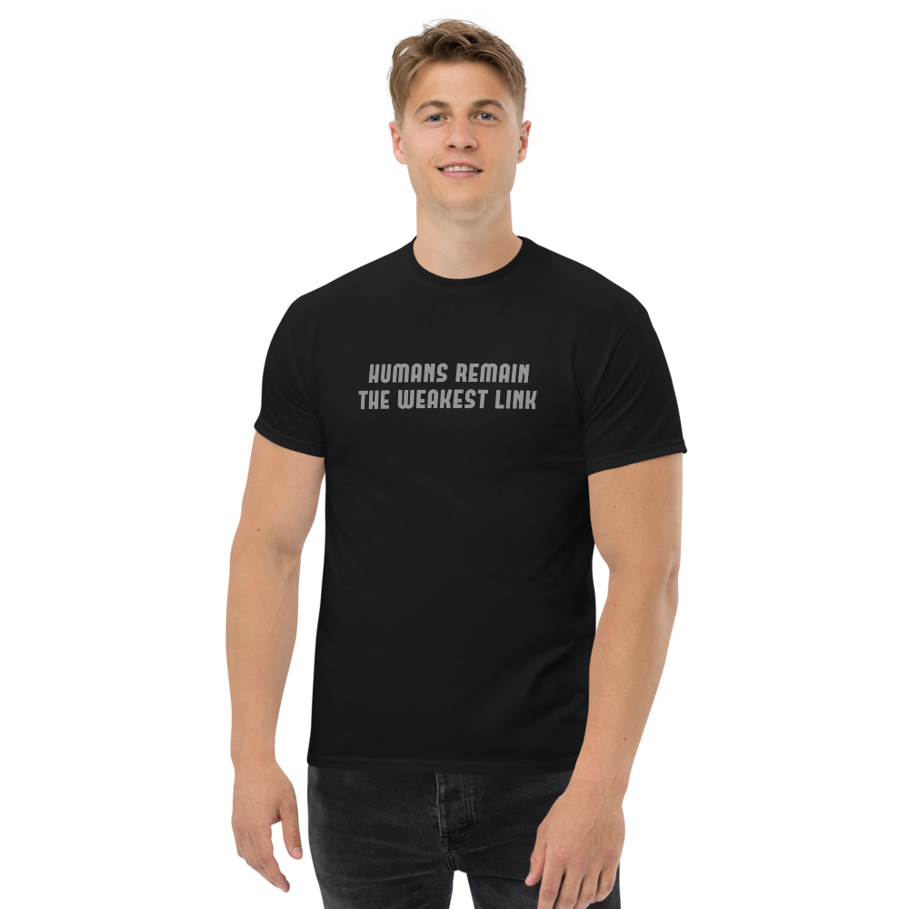 "Humans remain the weakest link" printed on a black unisex classic tee worn by a male