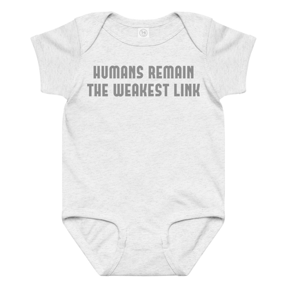 "Humans remain the weakest link" printed on a ash baby jersey bodysuit laying on a flat surface amongst other clothes