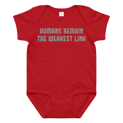 "Humans remain the weakest link" printed on a red baby jersey bodysuit laying on a flat surface amongst other clothes