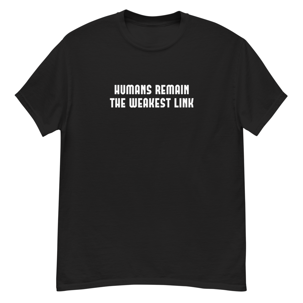 "Humans remain the weakest link" printed on a black unisex classic tee laying on a flat surface