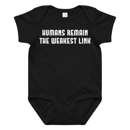 "Humans remain the weakest link" printed on a black baby jersey bodysuit laying on a flat surface amongst other clothes