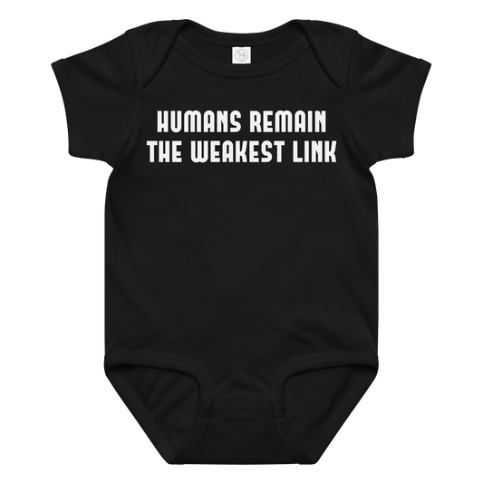 "Humans remain the weakest link" printed on a black baby jersey bodysuit laying on a flat surface amongst other clothes
