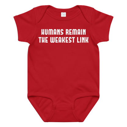 "Humans remain the weakest link" printed on a red baby jersey bodysuit laying on a flat surface amongst other clothes