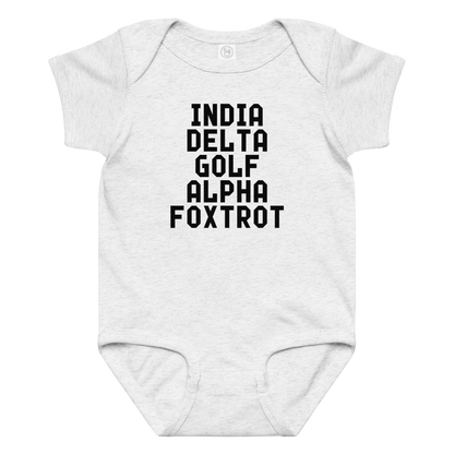"India Delta Golf Alpha Foxtrot" printed on a ash baby jersey bodysuit laying on a flat surface amongst other clothes