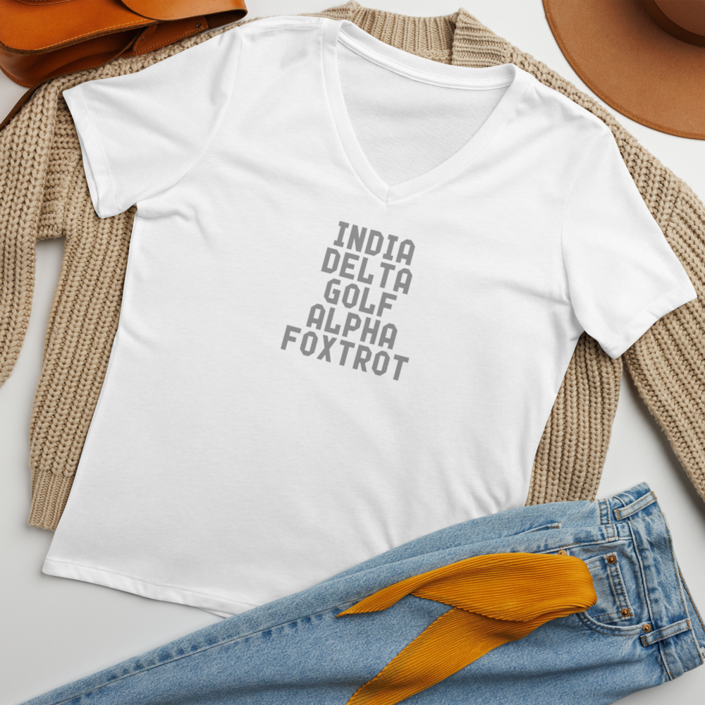 "India Delta Golf Alpha Foxtrot" printed on a solid white blend women's relaxed v-neck t-shirt laying on a flat surface amongst other clothes