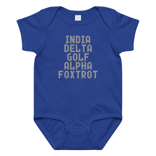 "India Delta Golf Alpha Foxtrot" printed on a royal baby jersey bodysuit laying on a flat surface amongst other clothes