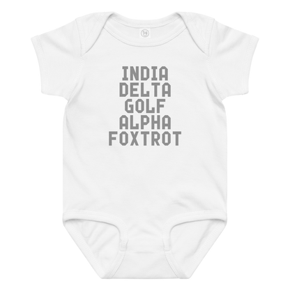 "India Delta Golf Alpha Foxtrot" printed on a white baby jersey bodysuit laying on a flat surface amongst other clothes