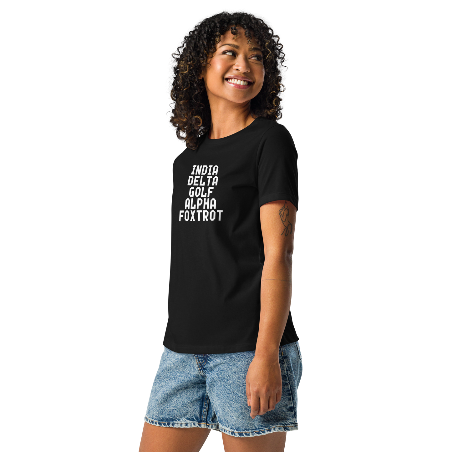 "India Delta Golf Alpha Foxtrot" printed on a black women's relaxed t-shirt worn by a female