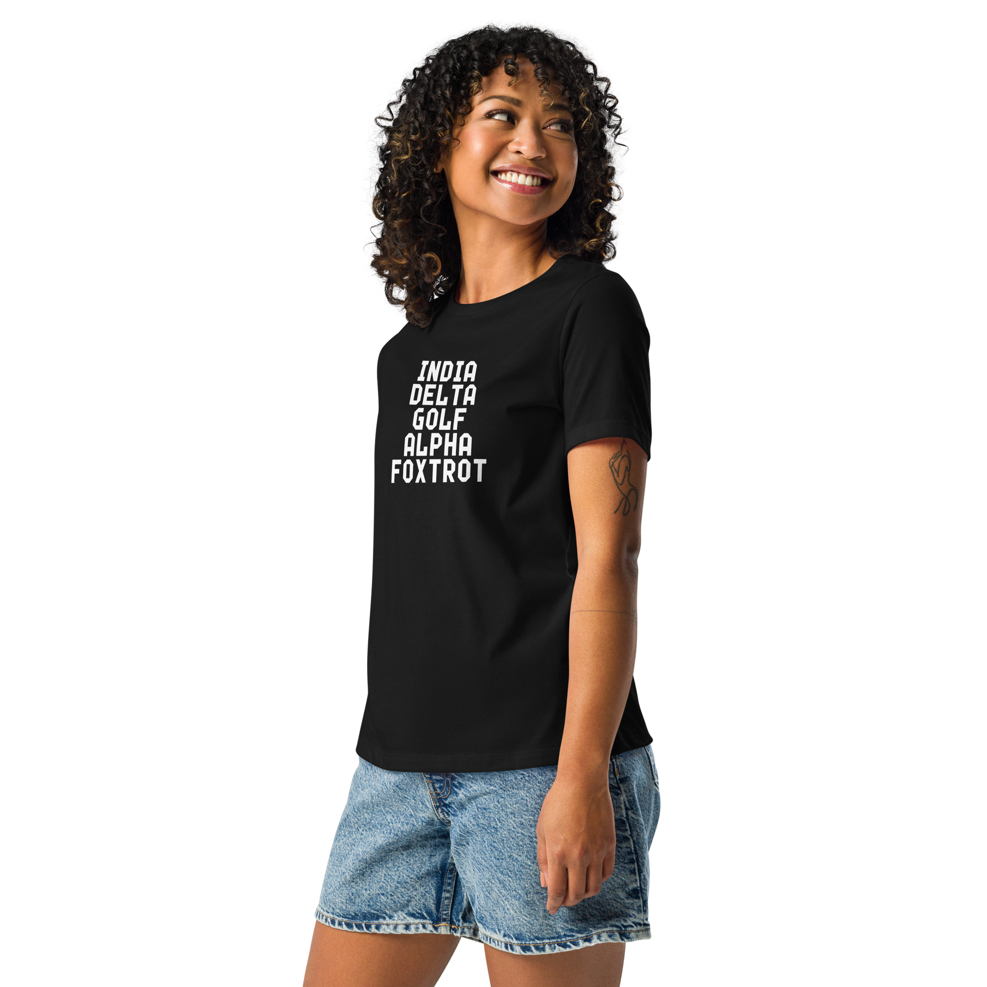 "India Delta Golf Alpha Foxtrot" printed on a black women's relaxed t-shirt worn by a female