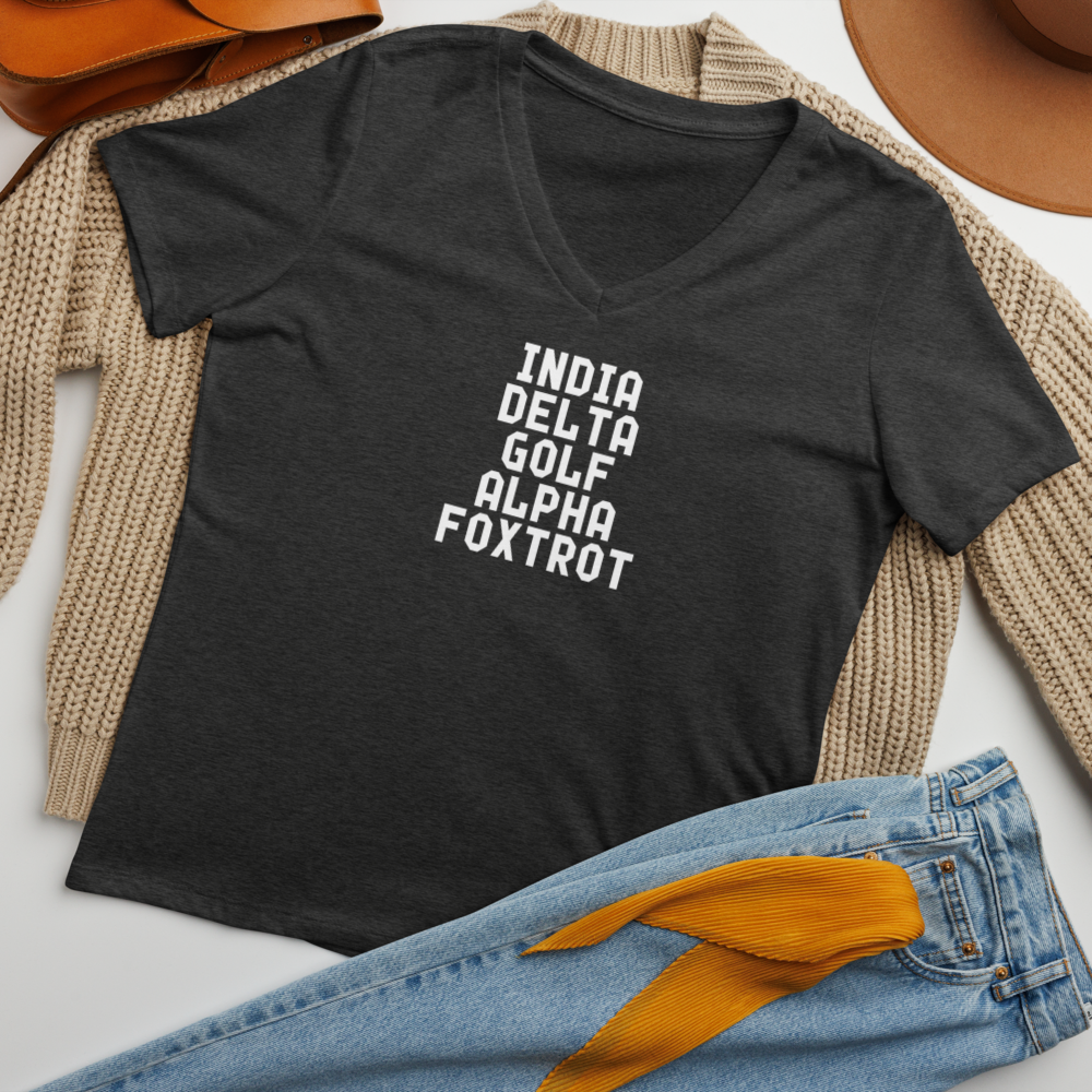"India Delta Golf Alpha Foxtrot" printed on a dark grey heather women's relaxed v-neck t-shirt laying on a flat surface amongst other clothes