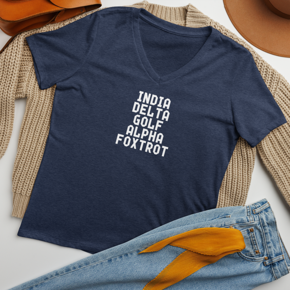 "India Delta Golf Alpha Foxtrot" printed on a heather navy women's relaxed v-neck t-shirt laying on a flat surface amongst other clothes
