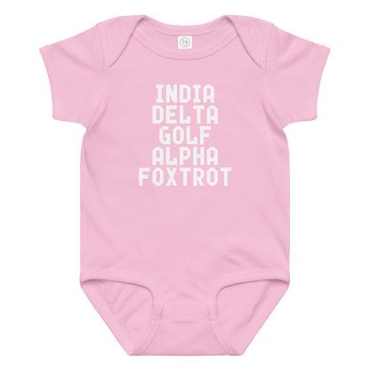 "India Delta Golf Alpha Foxtrot" printed on a pink baby jersey bodysuit laying on a flat surface amongst other clothes