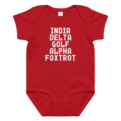 "India Delta Golf Alpha Foxtrot" printed on a red baby jersey bodysuit laying on a flat surface amongst other clothes