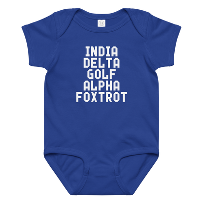 "India Delta Golf Alpha Foxtrot" printed on a royal baby jersey bodysuit laying on a flat surface amongst other clothes