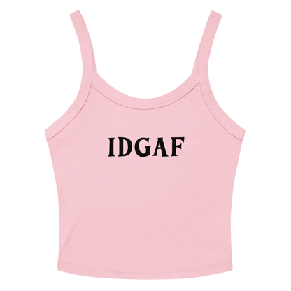 "IDGAF" printed on a solid pink blend women's micro-rib tanktop laying on a flat surface amongst sunglasses and shorts