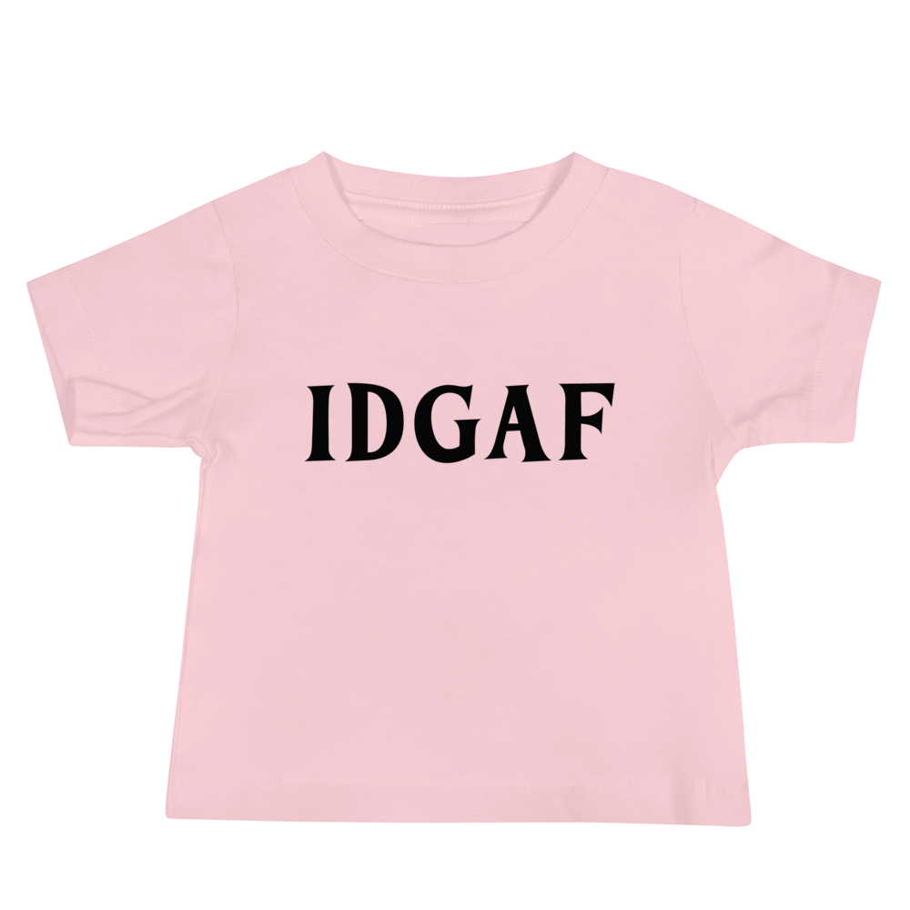 "IDGAF" printed on a pink baby jersey short sleeve tee laying on a flat surface