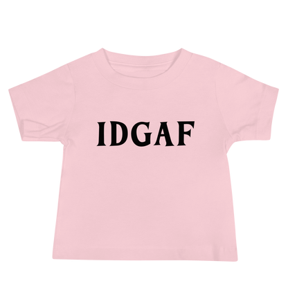 "IDGAF" printed on a pink baby jersey short sleeve tee laying on a flat surface