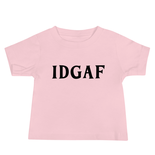"IDGAF" printed on a pink baby jersey short sleeve tee laying on a flat surface