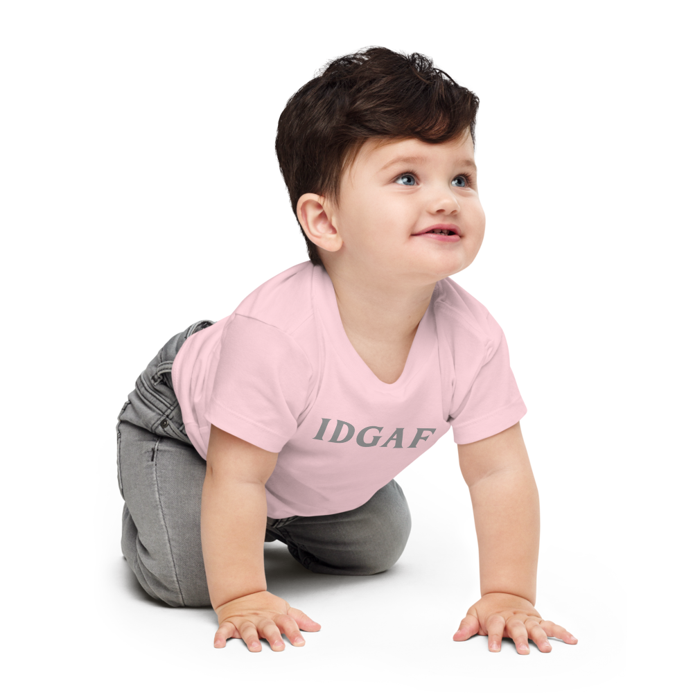 "IDGAF" printed on a pink baby jersey short sleeve tee worn by a male who is crawling