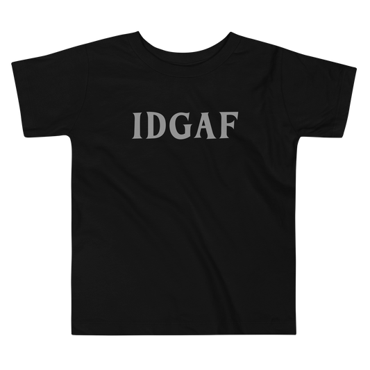 "IDGAF" printed on a black toddler short sleeve tee laying on a flat surface