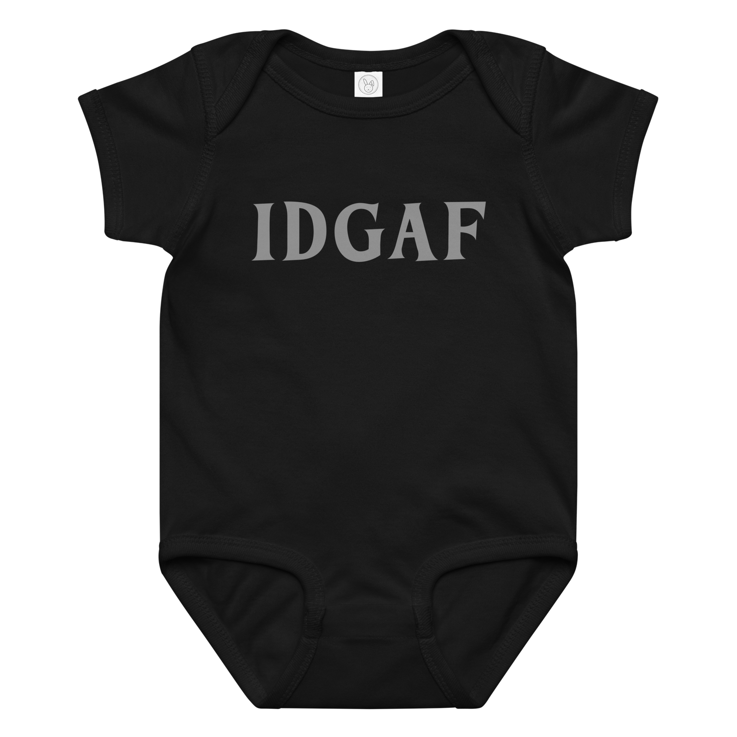 "IDGAF" printed on a black baby jersey bodysuit laying on a flat surface amongst other clothes