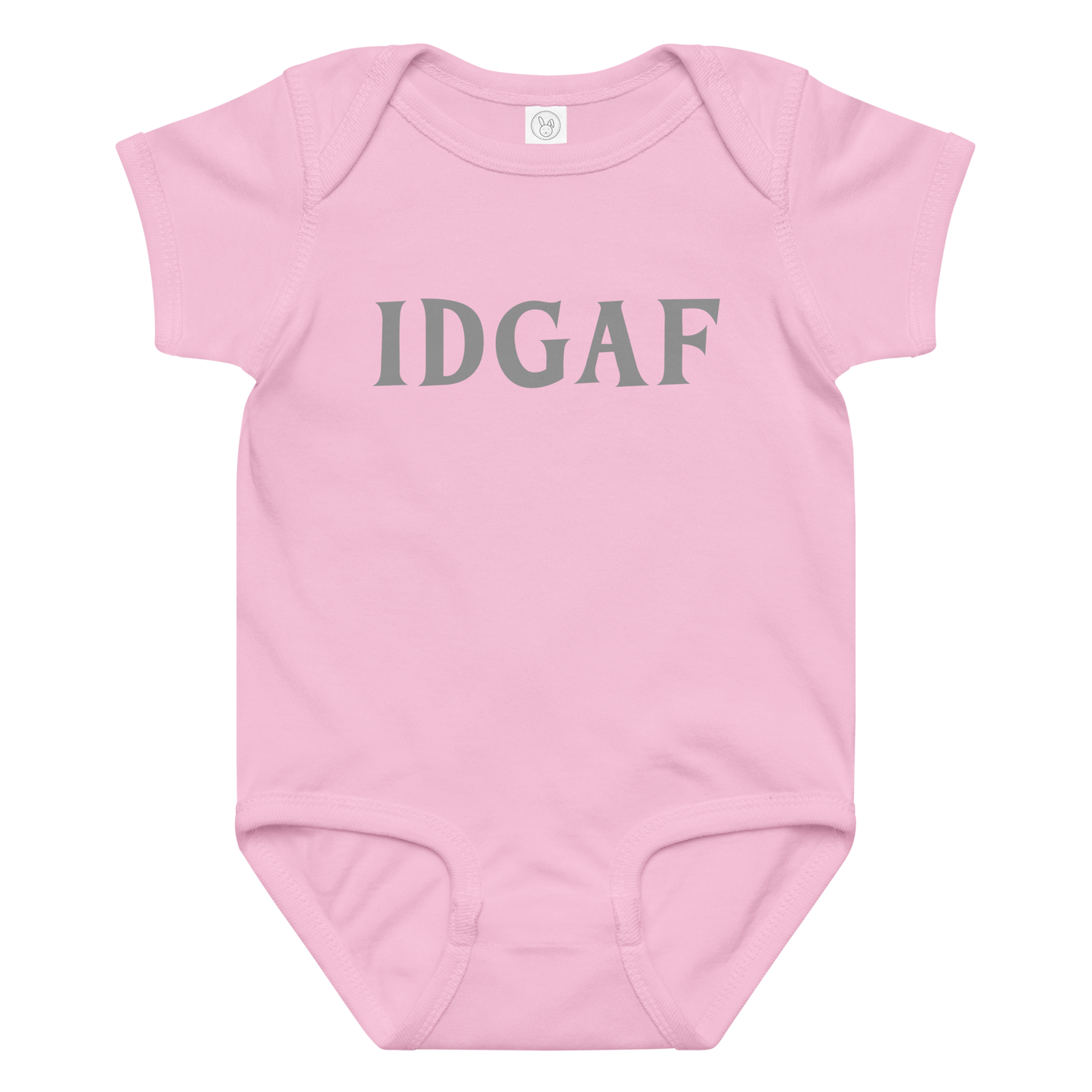 "IDGAF" printed on a pink baby jersey bodysuit laying on a flat surface amongst other clothes