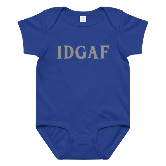 "IDGAF" printed on a royal baby jersey bodysuit laying on a flat surface amongst other clothes