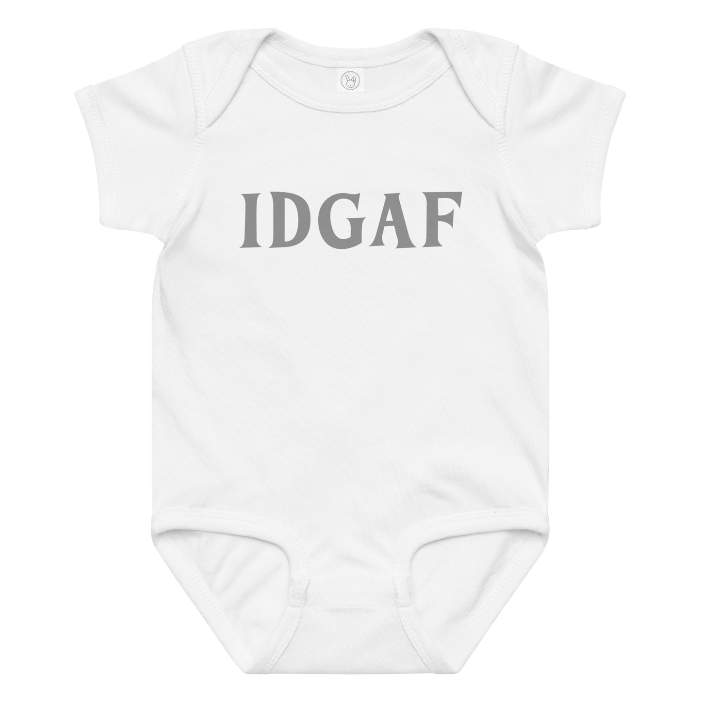 "IDGAF" printed on a white baby jersey bodysuit laying on a flat surface amongst other clothes